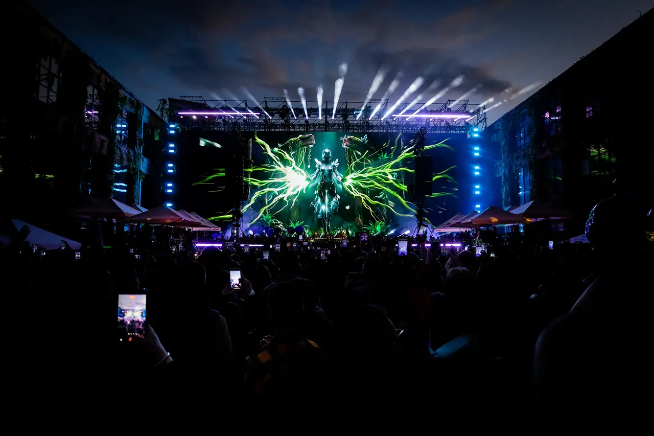 Audience filming stage visuals at a live show