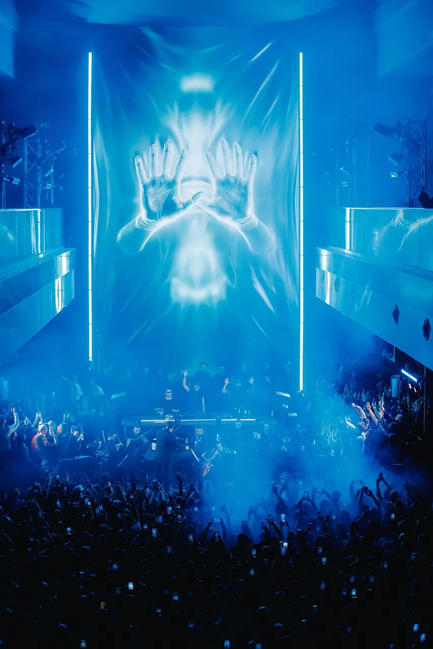 Vertical phone view of stage visuals at a live event