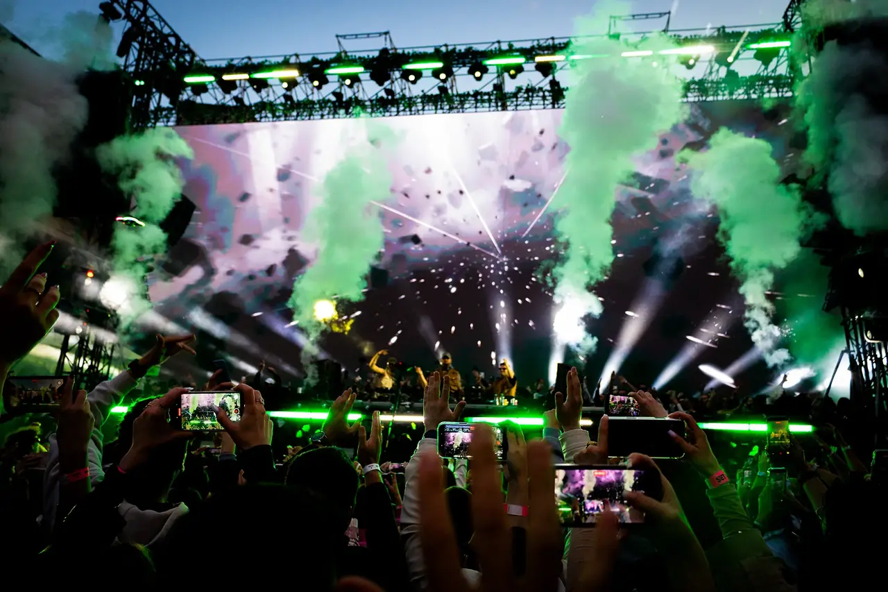 Crowd capturing the performance on their phones